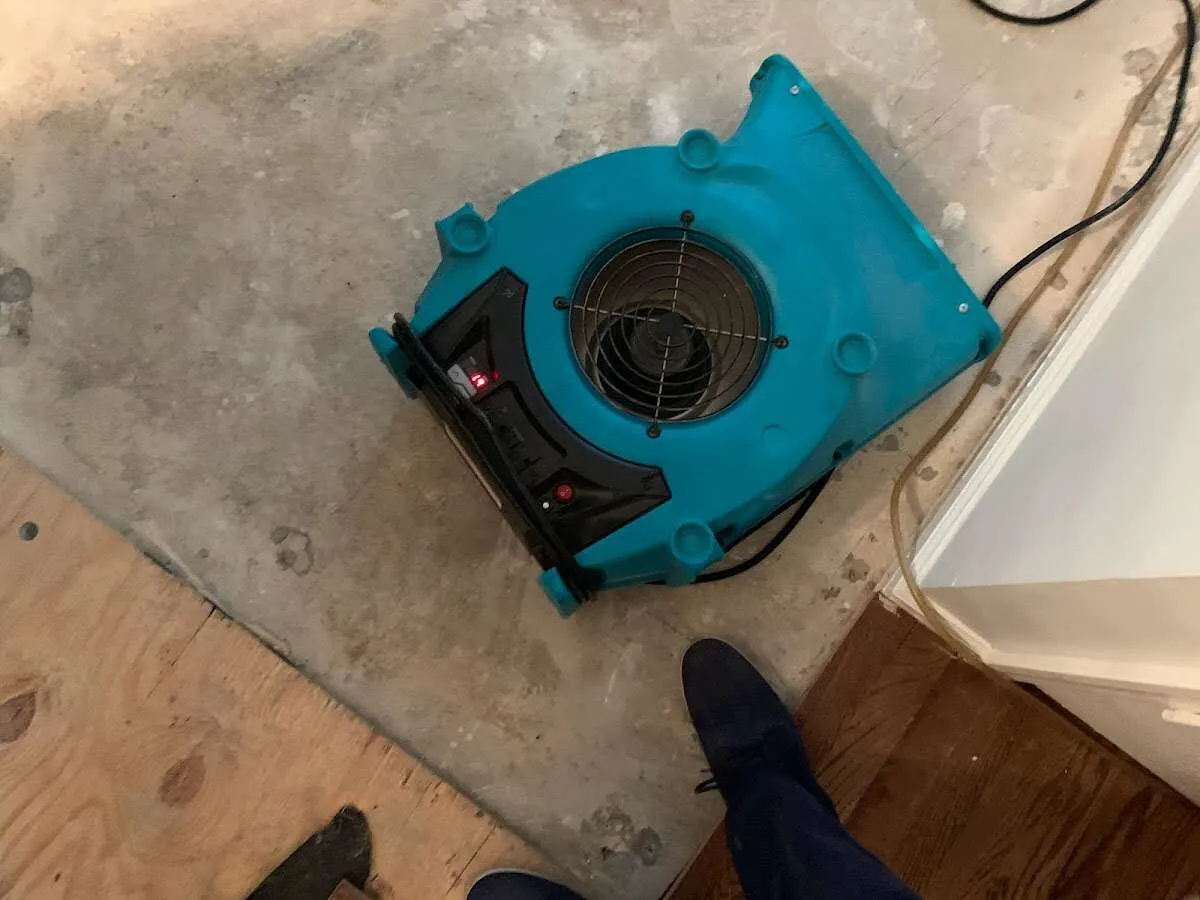 Air mover drying subfloor during Commercial Water Damage Restoration in Waller